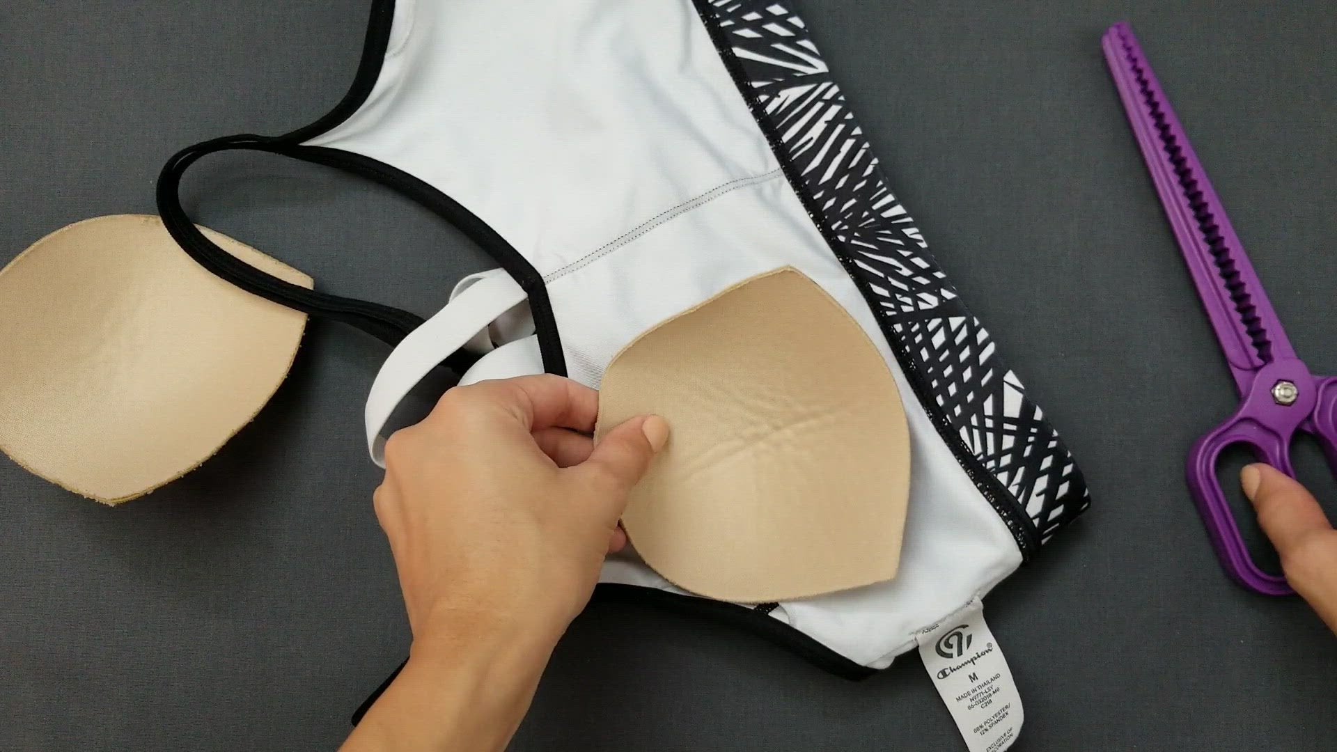 Showing an easy way to insert a removable padding back in a sports bra